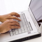 Hands Typing on a Laptop Computer